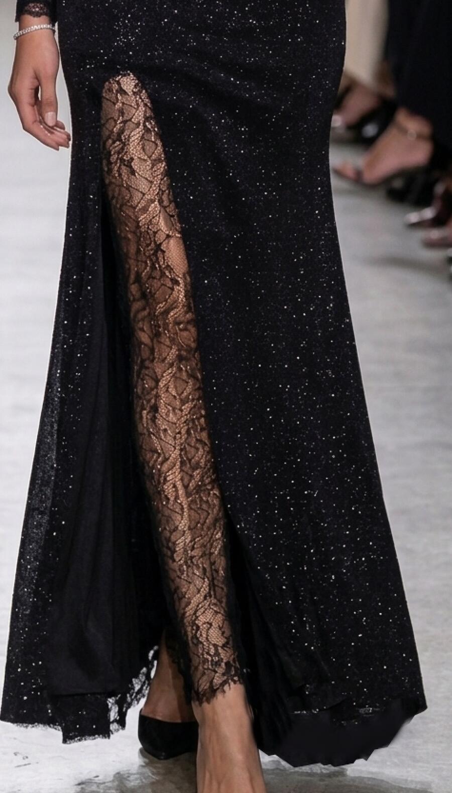 1056 Long black dress in glittery stretch velvet with an open back.